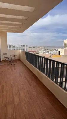 a balcony with a table and chairs on a building at Appartement De Standing - Face à La Plage -piscine in Mohammedia