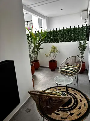 a room with two chairs and a table and plants at New Architect & Design Studio - CFC & Maarif in Casablanca