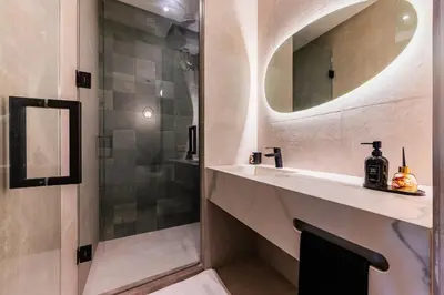 a bathroom with a shower and a sink and a mirror at New Architect & Design Studio - CFC & Maarif in Casablanca