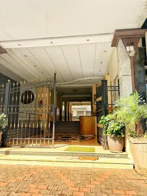 a lobby of a building with a gate and plants at La Gironde, Families & Friends stay in comfort in Casablanca
