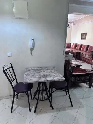 a table and chairs in a living room at La Gironde, Families & Friends stay in comfort in Casablanca