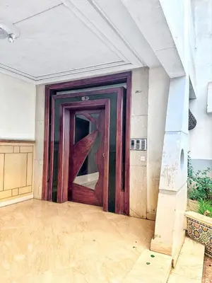 a large wooden door in a room with at La Gironde, Families & Friends stay in comfort in Casablanca