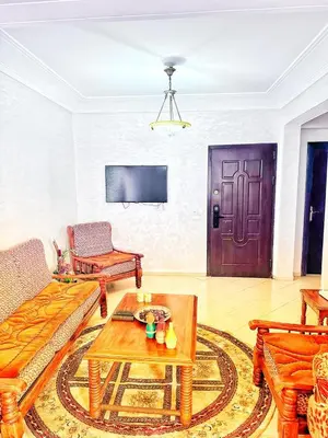 a living room with a couch and a table and a door at La Gironde, Families & Friends stay in comfort in Casablanca
