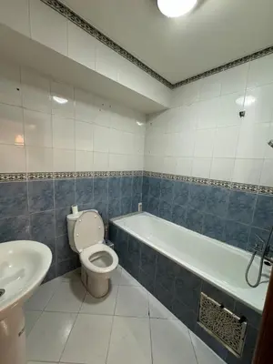 a bathroom with a toilet and a tub and a sink at Apartment near the soccer fields in Rabat