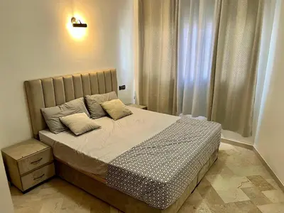 a bedroom with a bed and a window at Apartment near the soccer fields in Rabat