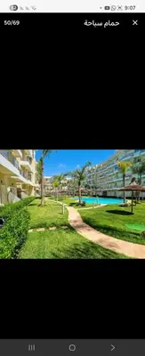a view of a park with trees and buildings at appartement with piscine & jardins - Détente à Bouznika, Rabat in Bouznika