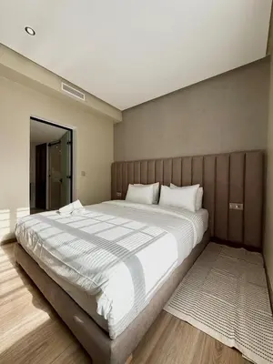 a bedroom with a large bed with white sheets at Villa 1 prestige with Pool & Private Guests Suites in Sidi Yahia az Zaʼer