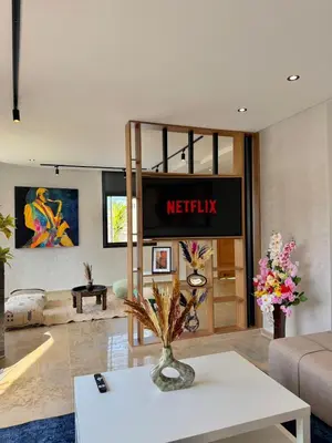 a living room with ametix sign on the wall at Villa 1 prestige with Pool & Private Guests Suites in Sidi Yahia az Zaʼer