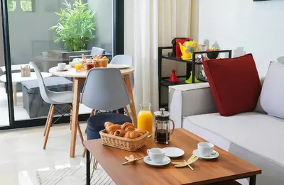 a living room with a table with food on it at Maya Suites - Premium Stay - Racine in Casablanca