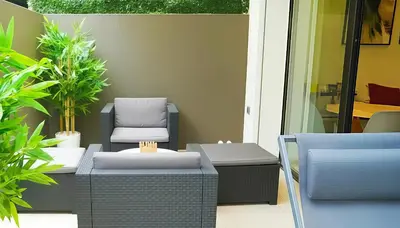 a patio with chairs and tables and plants at Maya Suites - Premium Stay - Racine in Casablanca