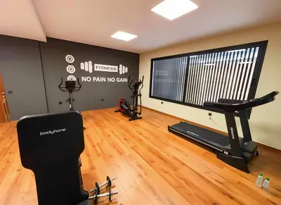 a gym with a treadmill and a flat screen tv at Maya Suites - Premium Stay - Racine in Casablanca