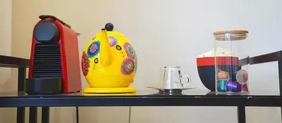 a table with a yellow vase on top at Maya Suites - Premium Stay - Racine in Casablanca