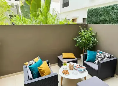 a patio with two chairs and a table with pillows at Maya Suites - Premium Stay - Racine in Casablanca
