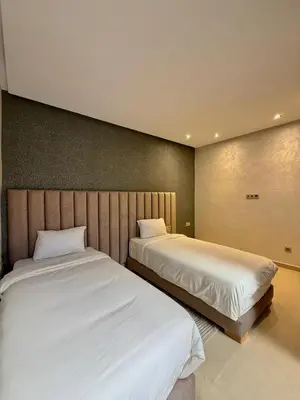 two beds sitting next to each other in a room at Villa 2 Évasion Urbaine, 3 Chambres, à 20 min de Rabat in Sidi Yahia az Zaʼer