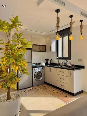 a kitchen with a sink and a washing machine at Villa 2 Évasion Urbaine, 3 Chambres, à 20 min de Rabat in Sidi Yahia az Zaʼer