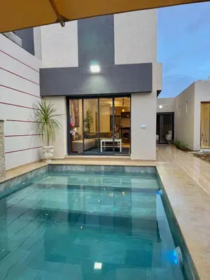 a swimming pool in front of a house at Villa 2 Évasion Urbaine, 3 Chambres, à 20 min de Rabat in Sidi Yahia az Zaʼer
