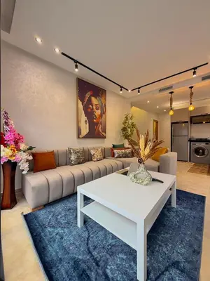a living room with a couch and a table at Villa 2 Évasion Urbaine, 3 Chambres, à 20 min de Rabat in Sidi Yahia az Zaʼer