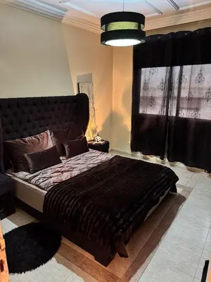 a bedroom with a large bed with a large window at Ideal appartement CAN2025 Grand Stade Rabat in Temara