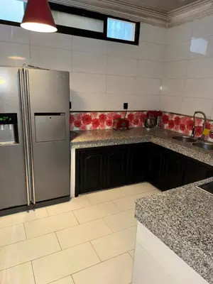a kitchen with a stainless steel refrigerator and counters at Ideal appartement CAN2025 Grand Stade Rabat in Temara