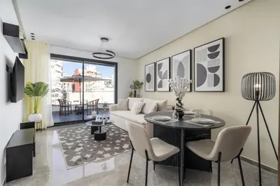 a living room with a couch and a table at Bright Modern Studio, Gauthier in Casablanca