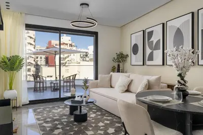 a living room with a couch and a table at Bright Modern Studio, Gauthier in Casablanca