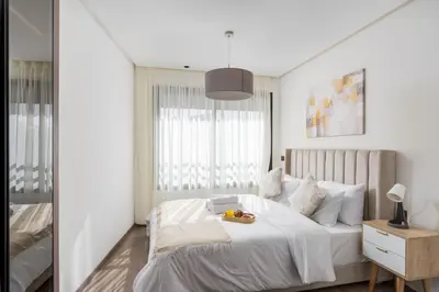 a bedroom with a white bed with a tray of fruit on it at Bright Modern Studio, Gauthier in Casablanca