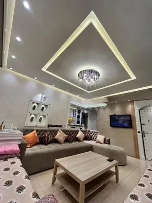 a living room with a couch and a table at Sympa appartement corniche in Casablanca