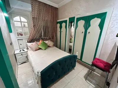 a bedroom with a bed with green and white walls at Sympa appartement corniche in Casablanca
