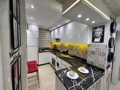 a kitchen with a black counter top in a room at Sympa appartement corniche in Casablanca