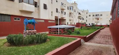 a courtyard with a fountain in the middle of a building at CAN Comfort 2 Bedrooms in Temara
