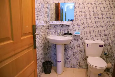 a bathroom with a toilet and a sink and a mirror at CAN Comfort 2 Bedrooms in Temara