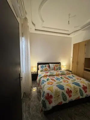 a bedroom with a bed with a colorful comforter at Apartment dar bouazza in Dar Bouazza