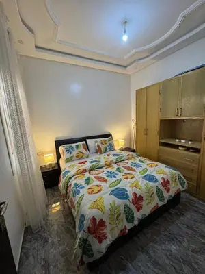 a bedroom with a bed with a colorful comforter at Apartment dar bouazza in Dar Bouazza