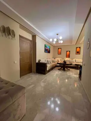 a large living room with a couch and a table at Appartment Maarif proche toutes commoditées in Casablanca