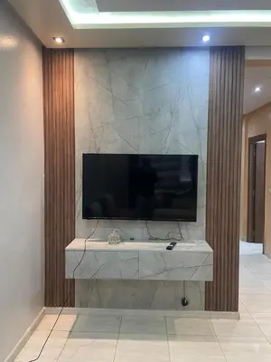 a large television on a wall in a room at Appartement andalous bouskoura in Bouskoura