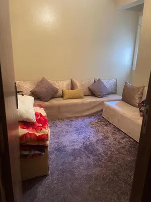 a living room with a couch and a rug at Appartement andalous bouskoura in Bouskoura