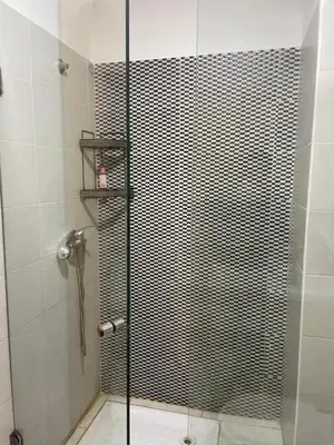 a shower with a glass door in a bathroom at Appartement andalous bouskoura in Bouskoura