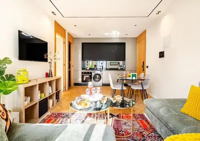 a living room with a couch and a table at Dynasty Estate - Appartement chic et central Yacoub Al Mansour in Casablanca
