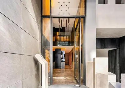 a hallway of a building with glass doors at Dynasty Estate - Appartement chic et central Yacoub Al Mansour in Casablanca