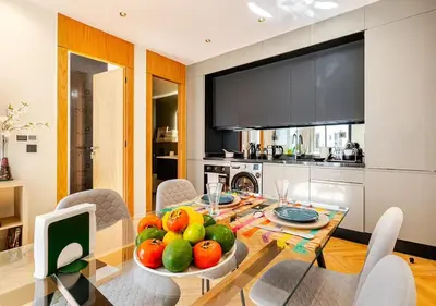 a dining room with a table with a bowl of fruit at Dynasty Estate - Appartement chic et central Yacoub Al Mansour in Casablanca