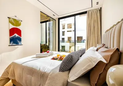 a bedroom with a bed and a large window at Dynasty Estate - Appartement chic et central Yacoub Al Mansour in Casablanca