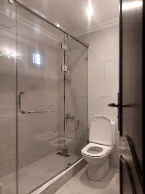 a bathroom with a toilet and a glass shower at Appartement Familial Casablanca in Casablanca