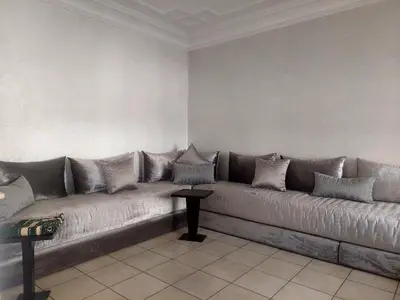 a couch with pillows on it in a living room at Appartement Familial Casablanca in Casablanca
