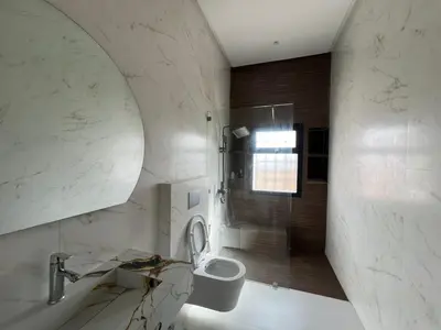 a bathroom with a shower and a toilet and a sink at Ferme villa in Skhirat