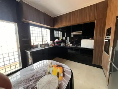 a kitchen with a glass table in the middle of it at Ferme villa in Skhirat