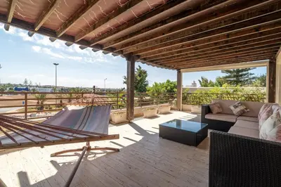 a patio with a hammock and a couch on a deck at Skhirat Oceanfront Villa 5 Bedrooms Direct Beach Access in Skhirat