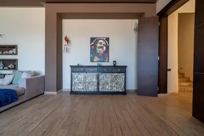a living room with a bed and a dresser at Skhirat Oceanfront Villa 5 Bedrooms Direct Beach Access in Skhirat