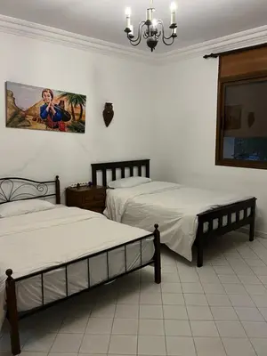 a bedroom with two beds and a painting on the wall at \u9526\u9ca4JinLi Villa 21 in Casablanca