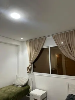 a room with a window and a bed and a table at App 8 in Rabat