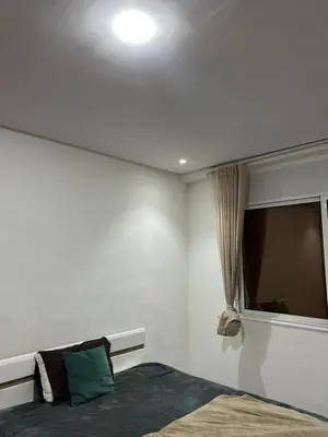 a bedroom with a bed and a television on the wall at App 8 in Rabat